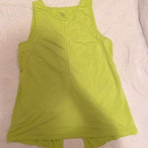 Green tank top with slit in back.